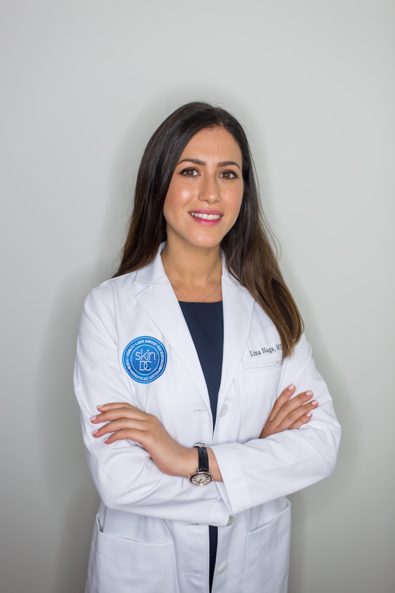 Lina Naga, MD, FAAD, board-certified dermatologist at SkinDC, specializing in cosmetic dermatology, preventative care, and treatments like Botox, CoolSculpting, and hair loss solutions in Arlington.